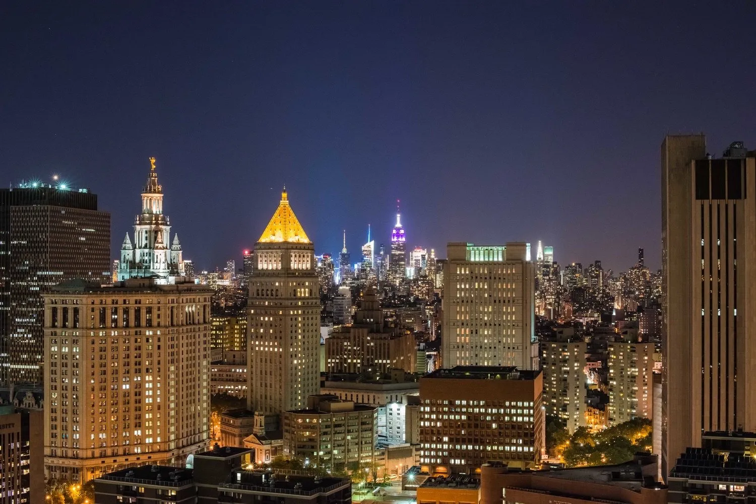 The New York City skyline illuminated at night.